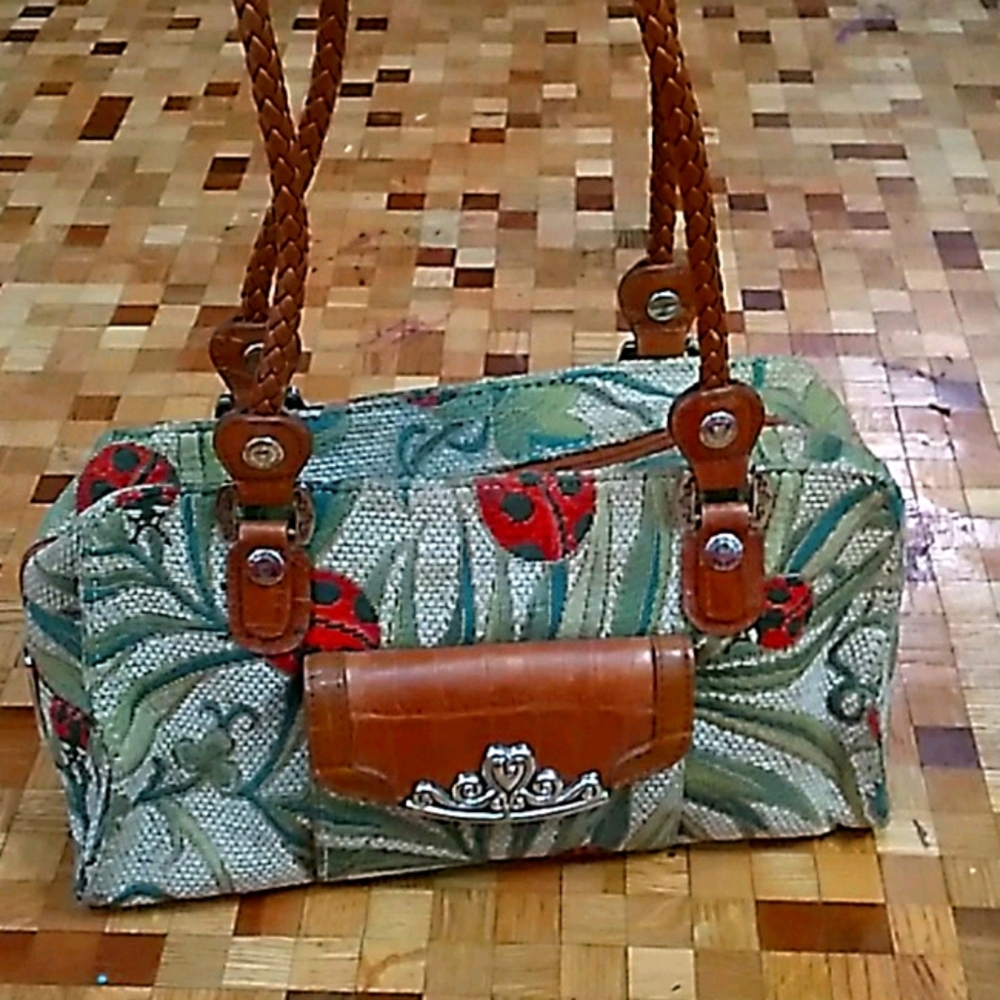 Lady bug and leather strap.  M.C. PURSE